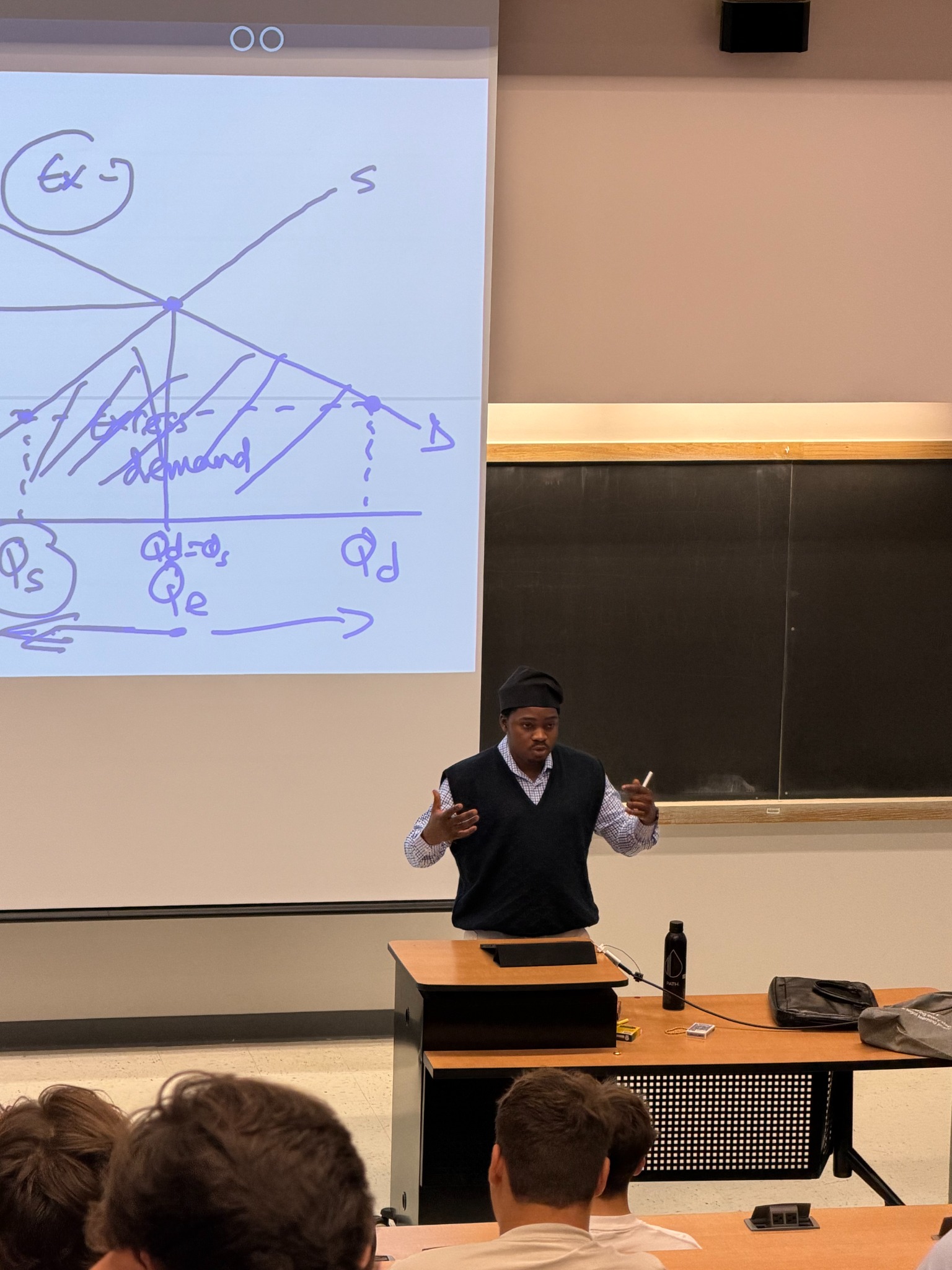 Muiz Olasupo teaching economics, classroom photograph 1
